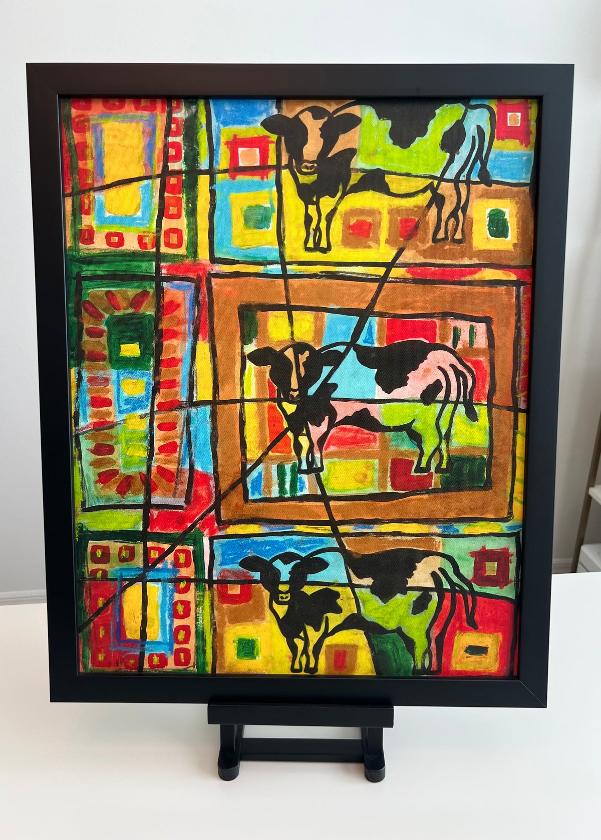 Funky cows print in black frame