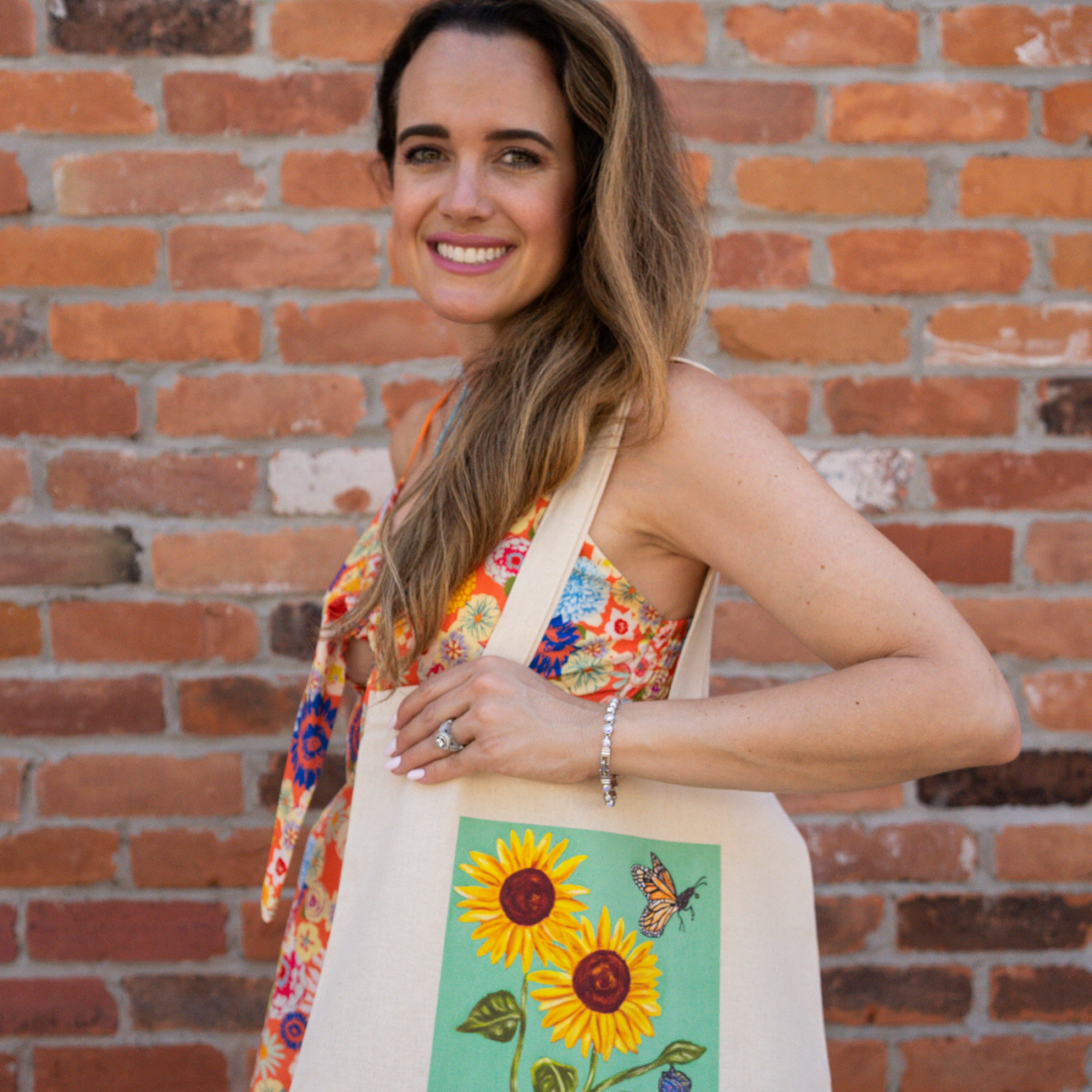 Sunflower tote bag with light green background.